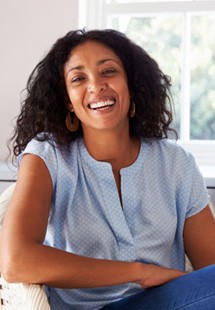 Woman smiling while sitting by window