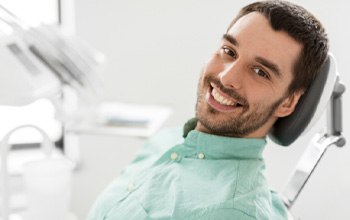 Smiling man leaning back in dental chair
