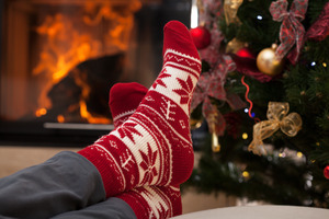 Putting feet up to relax in front of Christmas tree